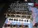 1996 Ford Mustang - Engine cylinder heads and intake manifold gaskets are laid out on a cloth for repair or after repair.