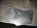 1995 Ford C-350 (Centurion Conversions) - A metal bracket sits on a workbench, showing signs of wear and modification.