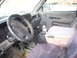 1995 Dodge 3500 - The interior of a Dodge pickup truck, the steering wheel, dashboard, and center console with a bottle in the cup holder.
