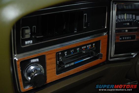 1972 Buick LeSabre interior dashboard with wood grain trim, climate controls, and speedometer