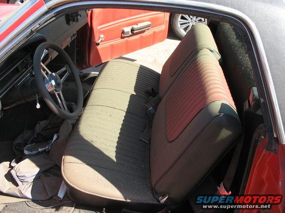 Interior of a 1971 Ford Ranchero showing green and red striped seats and red door panel