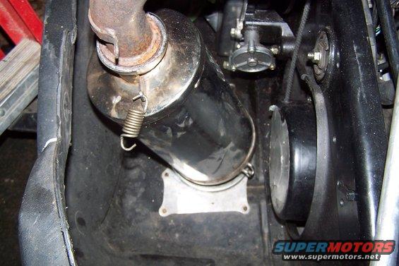 Close-up of snowmobile exhaust pipe and drive belt cover
