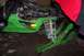 2004 Arctic Cat F-7 Firecat - A green snowmobile is shown with its front end lifted and engine exposed, parked indoors.