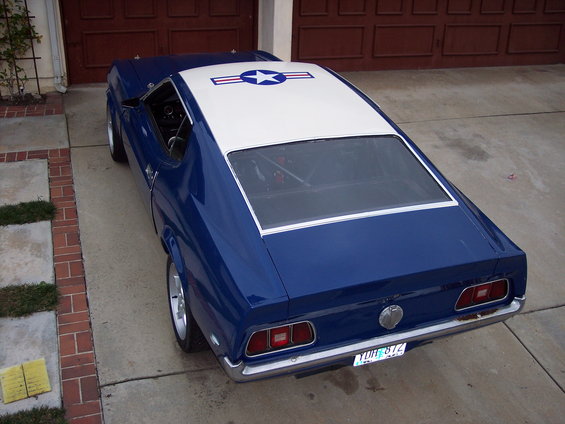 Blue 1971 Ford Mustang with white roof and an Air Force star decal on top