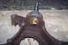 1990 Ford Bronco - This is a close-up view of a vehicle's ball joint assembly, showing its rusty metal components and a brass grease fitting.