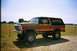 1979 Ford Bronco - This lifted 1978 Ford Bronco features a distinctive tri-color paint scheme and is parked outdoors.