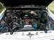 1985 Ford Crown Victoria LTD - The engine bay of a 1985 Ford Crown Victoria LTD is visible with the hood open, showing the engine components.