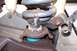 1990 Ford Bronco - Close-up view of a vehicle's suspension system, focusing on the ball joint assembly.