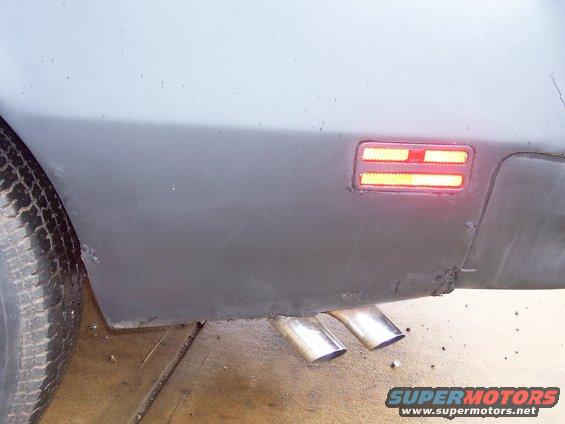 1978 Pontiac Trans Am rear quarter panel with dual exhaust pipes and illuminated side marker