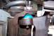 1990 Ford Bronco - Ball joint assembly with blue boot and zerk fitting, part of a vehicle's suspension system.