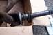 1990 Ford Bronco - A close-up view of a driveshaft component, showing a Spicer U-joint and a splined shaft end.