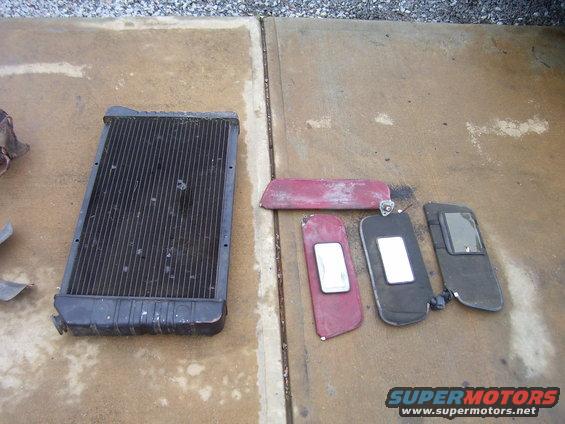 Radiator and three sun visors on concrete ground