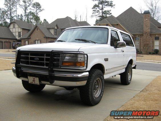 1996 Ford Bronco parked in a driveway with a brush guard and Alabama license plate