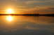 1985 Ford Ranger - A sunset casts a warm glow over a tranquil lake, reflecting the vibrant colors of the sky.
