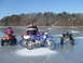 1995 Ford Mustang - Several off-road vehicles and their riders are gathered on a frozen body of water under a clear blue sky.