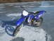 1995 Ford Mustang - A blue Yamaha dirt bike with studded tires sits on a frozen lake, ready for winter riding.