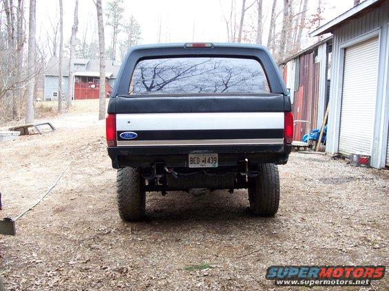 1992 Ford Bronco rear view, lifted with large tires. Ford oval badge visible on tailgate