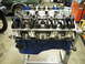 1968 Mercury Cougar - A disassembled engine block, painted blue on the oil pan, is mounted on a stand, showing its internal valve train components.