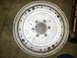 1968 Mercury Cougar - A metal flywheel with a toothed outer edge and multiple bolt holes is shown, with markings and a website logo visible.