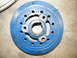 1968 Mercury Cougar - A blue crankshaft pulley with stamped numbers is shown, with a toothed belt visible in the upper left corner.