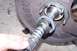 1990 Ford Bronco - Close-up of a splined axle shaft being held, with seals and part of a bearing assembly visible.