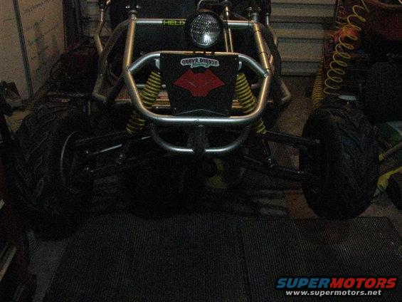 Front view of a go-kart with yellow springs and a "Grave Digger" sticker