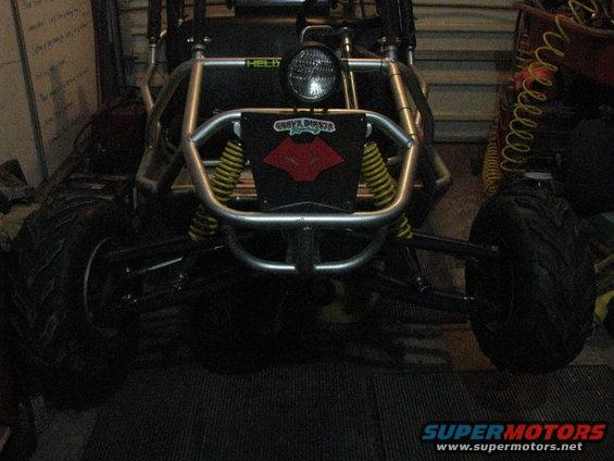 Front view of a go-kart with a roll cage, large tires, and a black plate with a red logo that says 'GRAVE DIGGER'