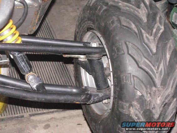 Go-kart front suspension with yellow spring and black tire