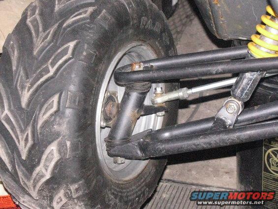 Go-kart tire and suspension components with yellow shock absorber