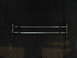 2006 Ford F1 - Two metal tie rods are shown against a dark background.