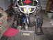 2006 Ford F1 - A go-kart frame and its suspension components are laid out in a garage setting.