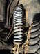 1978 Ford Bronco - The suspension system of a vehicle, a coil spring and a portion of a tire, is shown in detail.