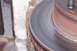 1990 Ford Bronco - A close-up view of a worn brake rotor, showing concentric scoring from use.