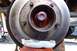 1990 Ford Bronco - Close-up of a vehicle's wheel hub assembly, showing the brake rotor and greased components.
