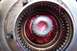 1990 Ford Bronco - Close-up view of a wheel hub assembly filled with red grease, likely for maintenance or repair.