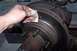 1990 Ford Bronco - Cleaning the brake rotor to remove surface rust before reassembly.