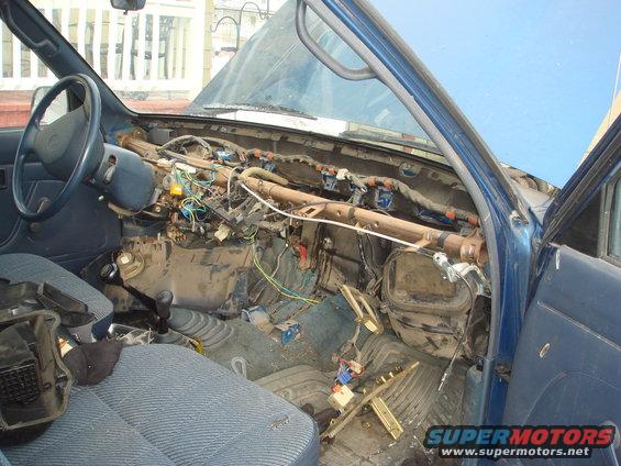 Blue 1991 Toyota Tacoma interior with dashboard removed, showing exposed wires and components