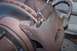 1990 Ford Bronco - A close-up view of a vehicle's brake caliper and rotor, showing signs of wear and rust.