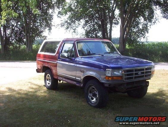Ford Bronco with a 1992 F-150 front clip, red rear quarter panel, and blue hood
