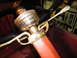 1913 Ford Model T - Detail of a steering column with brass fittings and a red painted lever.