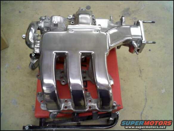 chrome intake manifold on a red stand
