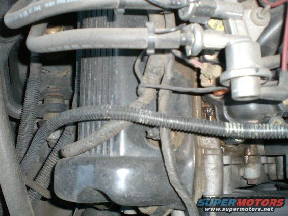 Close-up of engine parts with hoses and wiring