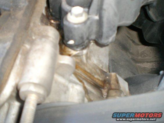 Engine part with fluid leak, close-up view