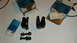 1979 Ford Bronco - Two black Ford Bronco parts, possibly rocker arms, are shown with bolts and original Ford Service Parts packaging.