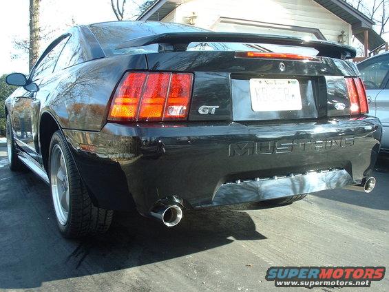 Rear view of a black 2002 Ford Mustang GT with a spoiler and dual exhaust pipes