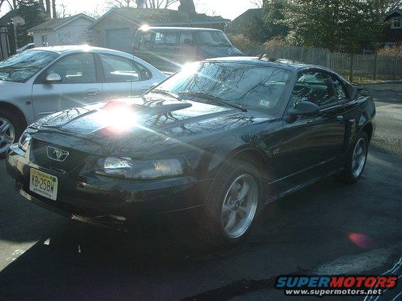 Black Ford Mustang GT with a hood scoop and a New Jersey license plate