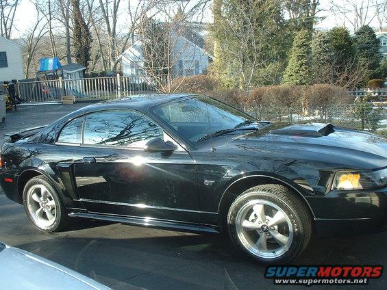 Black 2002 Ford Mustang GT parked in a driveway