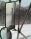1995 Mercury Grand Marquis - View from inside a truck cab shows side mirrors reflecting a snow-covered landscape and road.