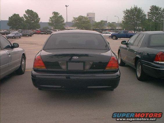 Rear view of a black 2000 Ford Crown Victoria parked in a lot