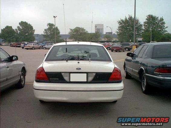 White 2000 Ford Crown Victoria rear view with antennas